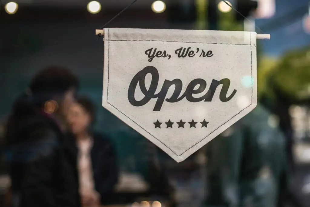 An open sign in the window of a small business